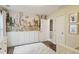 Bedroom with hardwood floors, playful wallpaper, and white wainscoting at 2023 Yellow Finch Trl, Atlanta, GA 30316