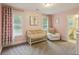 Pink Bedroom with gray carpet, white furniture, and decor at 2023 Yellow Finch Trl, Atlanta, GA 30316