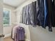 Walk-in closet with shelving, rods, and neatly organized shirts at 2023 Yellow Finch Trl, Atlanta, GA 30316