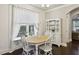 Cozy dining area featuring a round table, bright window, and decorative shelving, ideal for Gathering meals at 2023 Yellow Finch Trl, Atlanta, GA 30316