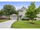 Charming home with green lawn, attached garage, and inviting entrance at 2023 Yellow Finch Trl, Atlanta, GA 30316