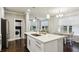 Open kitchen features an island with stainless steel appliances and leads into a dining area with seating at 2023 Yellow Finch Trl, Atlanta, GA 30316