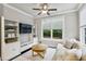Cozy living room features a large window, modern furniture, and custom built-in shelving at 2023 Yellow Finch Trl, Atlanta, GA 30316