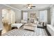 Inviting living room with modern decor, large sectional sofa, and stylish area rug at 2023 Yellow Finch Trl, Atlanta, GA 30316