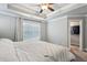 Serene main bedroom with a tray ceiling, a ceiling fan, and a walk-in closet at 2023 Yellow Finch Trl, Atlanta, GA 30316