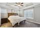 Serene main bedroom with tray ceilings, a wooden headboard, and neutral decor at 2023 Yellow Finch Trl, Atlanta, GA 30316