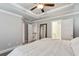 Bright main bedroom featuring a ceiling fan, a full length mirror, and a connecting bathroom at 2023 Yellow Finch Trl, Atlanta, GA 30316