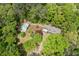 Overview of a home featuring a private pool surrounded by mature trees and landscaping at 2377 Pine Mountain Rd, Kennesaw, GA 30152