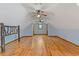 Large attic featuring wood floors, natural light, and ceiling fans at 2377 Pine Mountain Rd, Kennesaw, GA 30152