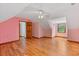 Spacious attic area showcasing hardwood floors, good natural light, and a ceiling fan at 2377 Pine Mountain Rd, Kennesaw, GA 30152