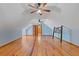 Bright attic area featuring wood floors, rustic decor, and ceiling fans at 2377 Pine Mountain Rd, Kennesaw, GA 30152