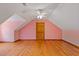 Attic room with wood floors and light pink paint at 2377 Pine Mountain Rd, Kennesaw, GA 30152