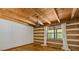 Bright bedroom with wooden walls, wooden floors, a window with nature views, and a chandelier at 2377 Pine Mountain Rd, Kennesaw, GA 30152