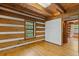 Bedroom showcasing wood plank walls, wood floors, and a picturesque view from a bright window at 2377 Pine Mountain Rd, Kennesaw, GA 30152