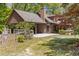 Exterior of a log home featuring an attached carport and well-maintained yard at 2377 Pine Mountain Rd, Kennesaw, GA 30152