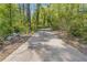 Long, private driveway leading through a wooded area, ensuring seclusion at 2377 Pine Mountain Rd, Kennesaw, GA 30152