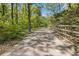 Scenic driveway winds through lush trees, adding to the property's serene setting at 2377 Pine Mountain Rd, Kennesaw, GA 30152