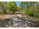 Gravel driveway leading to a log home surrounded by beautiful trees, nature, and privacy at 2377 Pine Mountain Rd, Kennesaw, GA 30152