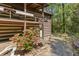 Log home exterior featuring a porch and garden with stone accents at 2377 Pine Mountain Rd, Kennesaw, GA 30152