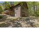 Back of a log home with a porch, and landscaped backyard at 2377 Pine Mountain Rd, Kennesaw, GA 30152
