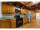 Well-equipped kitchen with stainless steel refrigerator, oven, microwave, granite countertops and wooden cabinets at 2377 Pine Mountain Rd, Kennesaw, GA 30152