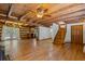 Spacious living room with wooden beams, hardwood floors, staircase, and natural light streaming through french doors at 2377 Pine Mountain Rd, Kennesaw, GA 30152