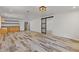Open floor plan featuring wood-look tile floors and a barn door, seamlessly connecting living spaces at 2377 Pine Mountain Rd, Kennesaw, GA 30152