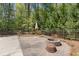 Outdoor patio with a fire pit area, perfect for entertaining surrounded by a wooded lot at 2377 Pine Mountain Rd, Kennesaw, GA 30152