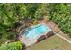 Aerial view of a sparkling pool surrounded by manicured landscaping and mature trees at 2377 Pine Mountain Rd, Kennesaw, GA 30152