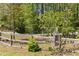Fenced yard with mature trees providing privacy and a defined property line at 2377 Pine Mountain Rd, Kennesaw, GA 30152