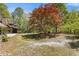 Manicured yard featuring a gravel path and a stunning red-leafed tree, enhancing the home's exterior at 2377 Pine Mountain Rd, Kennesaw, GA 30152