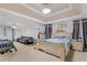 Expansive bedroom with a seating area, bed, and ceiling fan at 240 Creekview Blvd, Covington, GA 30016