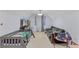 Large bedroom featuring a bed, couch, shelving unit, and window at 240 Creekview Blvd, Covington, GA 30016