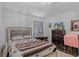Well-lit bedroom featuring a full bed, dresser, and decor at 240 Creekview Blvd, Covington, GA 30016