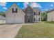 Charming two-story home featuring a stone facade, a well-maintained lawn, and a two car attached garage at 240 Creekview Blvd, Covington, GA 30016