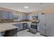 Functional kitchen with painted cabinets, tiled backsplash, stainless steel appliances, and ample counter space at 240 Creekview Blvd, Covington, GA 30016