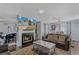 Open concept living room with a fireplace, a ceiling fan, a comfortable sofa, and a dining area at 240 Creekview Blvd, Covington, GA 30016