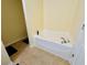 Bathroom featuring a soaking tub with chrome fixtures and tile floor at 6156 Thorncrest Dr, Tucker, GA 30084