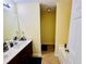 Bathroom featuring double sinks, dark wood vanity, and tile flooring at 6156 Thorncrest Dr, Tucker, GA 30084