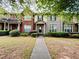 Charming townhome featuring a manicured front lawn and inviting entryway at 6156 Thorncrest Dr, Tucker, GA 30084