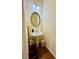 Powder room featuring a pedestal sink, oval mirror, and modern lighting fixtures at 6156 Thorncrest Dr, Tucker, GA 30084