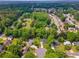 Expansive aerial view of a neighborhood with lush greenery, homes, and tree-lined streets at 831 Terrace Trce, Lawrenceville, GA 30044
