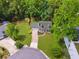 Aerial view of charming home with well-manicured lawn, mature trees, and a long driveway at 831 Terrace Trce, Lawrenceville, GA 30044
