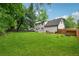 Expansive backyard with lush green grass, a wood fence, and a two-story home at 831 Terrace Trce, Lawrenceville, GA 30044