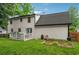 Two story house with a back yard, featuring a wood deck and a vegetable garden at 831 Terrace Trce, Lawrenceville, GA 30044