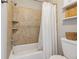 Bathroom featuring tiled shower with built-in shelving, a white toilet, and clean, neutral finishes at 831 Terrace Trce, Lawrenceville, GA 30044