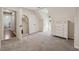 Bright bedroom with plush carpet, white dresser, and an arched doorway with a view into the next room at 831 Terrace Trce, Lawrenceville, GA 30044