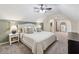 Comfortable bedroom featuring plush carpet, neutral tones, arched entryway, and a ceiling fan at 831 Terrace Trce, Lawrenceville, GA 30044