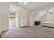 Large bedroom with plush carpet, neutral walls, arched doorway, and lots of natural light at 831 Terrace Trce, Lawrenceville, GA 30044