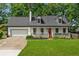 Charming home featuring a red front door, front porch and manicured front lawn at 831 Terrace Trce, Lawrenceville, GA 30044